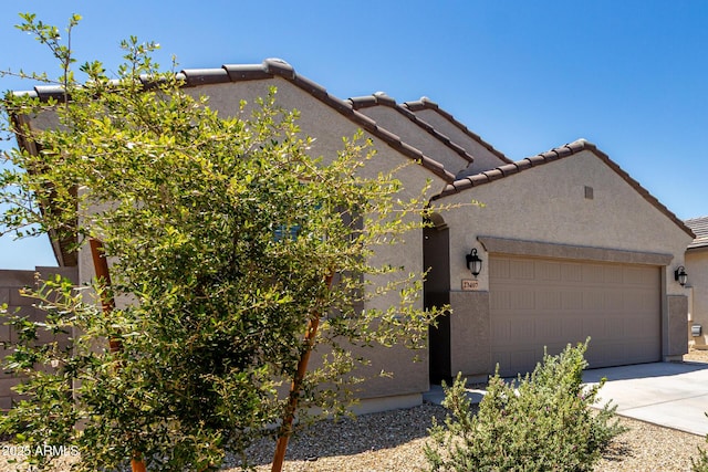 23407 W Winslow Ave, Buckeye, AZ 85326 - view of property exterior featuring stucco siding, driveway, an attached garage, and a tile roof