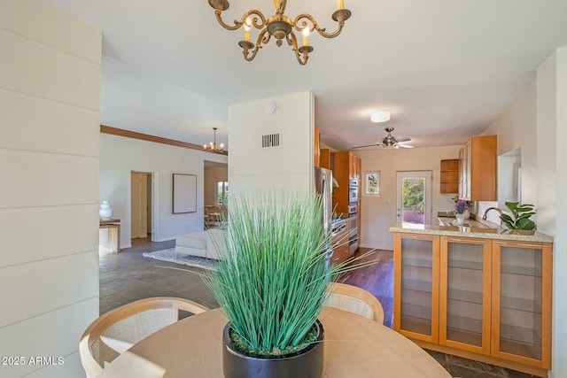 dining area with ceiling fan with notable chandelier