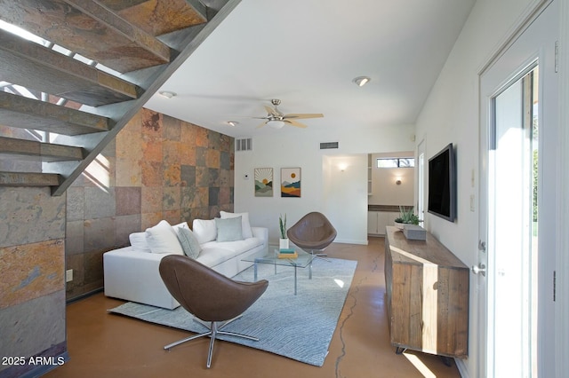 living room featuring concrete floors and ceiling fan