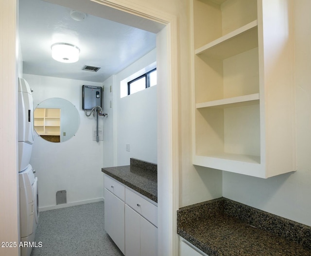 bathroom featuring vanity and stacked washer / drying machine