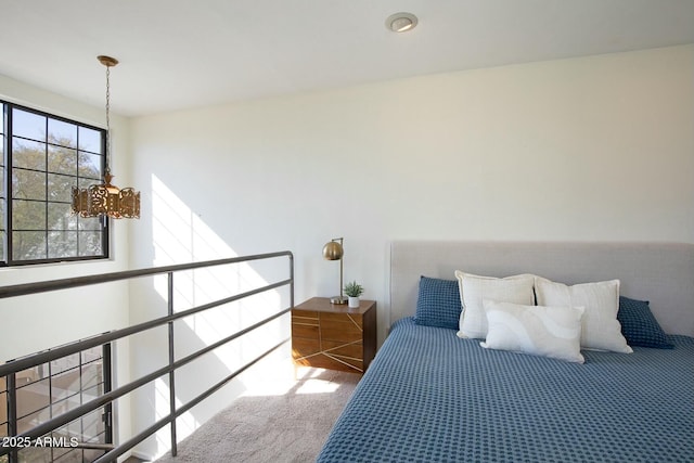 carpeted bedroom with a notable chandelier