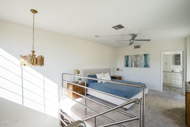 carpeted bedroom featuring connected bathroom and ceiling fan with notable chandelier