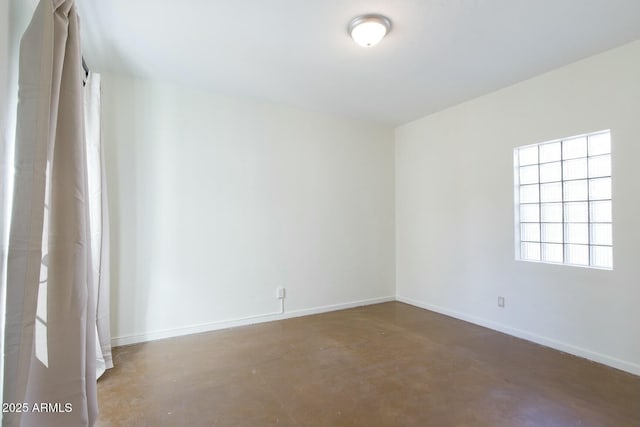 spare room featuring concrete flooring