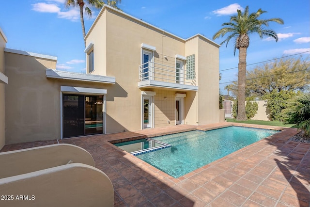 view of swimming pool featuring a patio and an in ground hot tub