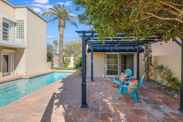 view of swimming pool featuring a patio and a pergola