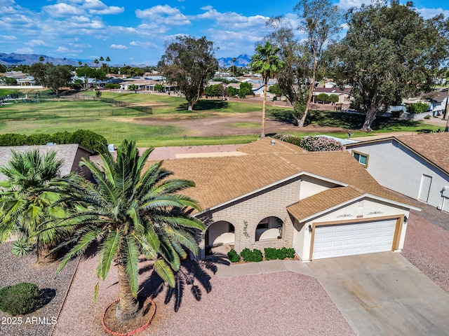 811 S 79th Way, Mesa, AZ 85208 - view of front of house with an attached garage, concrete driveway, a mountain view, a residential view, and stucco siding