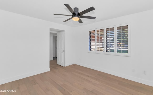 spare room featuring light hardwood / wood-style floors and ceiling fan