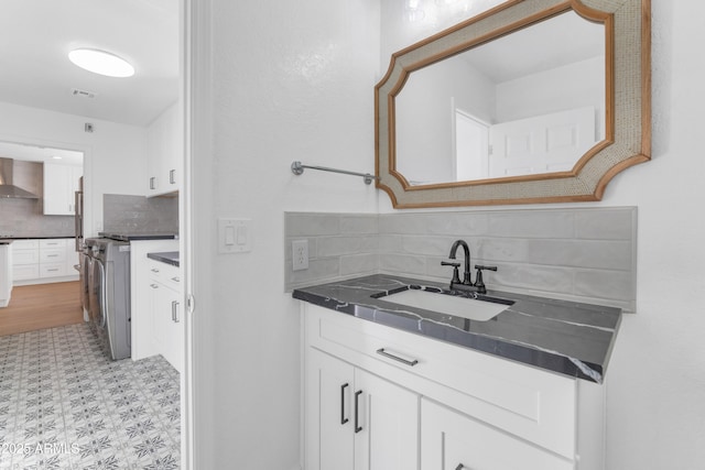 interior space with sink and backsplash