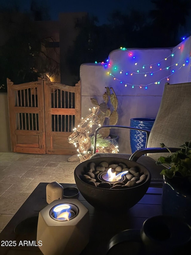 patio at twilight featuring a gate