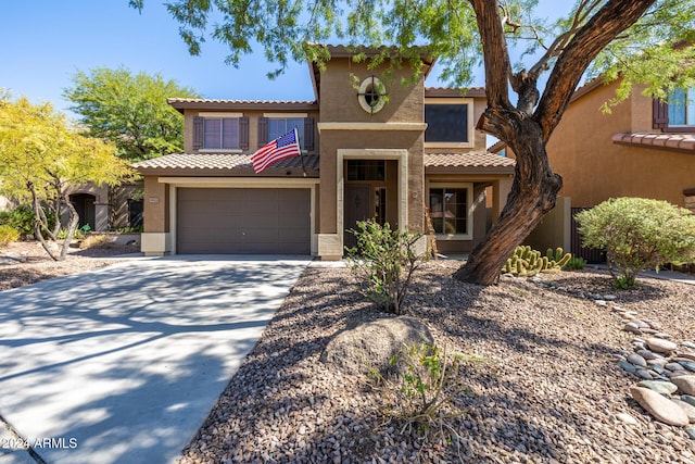 mediterranean / spanish-style home with a garage