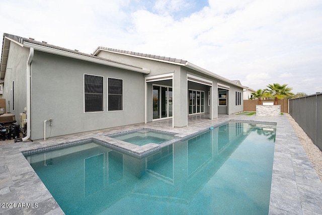 view of swimming pool with an in ground hot tub and a patio area