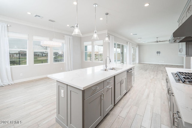 kitchen featuring gray cabinets, ceiling fan, hanging light fixtures, and sink