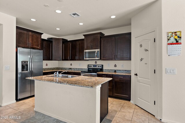3326 N 31st St, Mesa, AZ 85213 - kitchen with appliances with stainless steel finishes, light stone counters, light tile patterned flooring, a kitchen island with sink, and recessed lighting