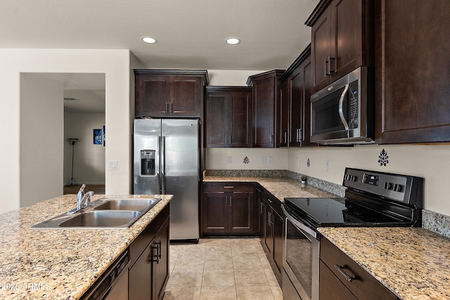 3326 N 31st St, Mesa, AZ 85213 - kitchen featuring stainless steel appliances, dark brown cabinets, light tile patterned floors, recessed lighting, and light stone countertops