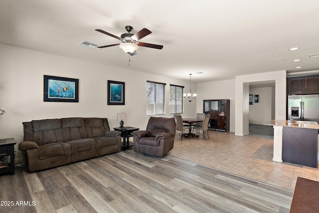 3326 N 31st St, Mesa, AZ 85213 - living area with a ceiling fan, a chandelier, recessed lighting, and light wood finished floors