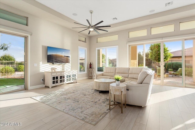 living room featuring light wood-type flooring and ceiling fan