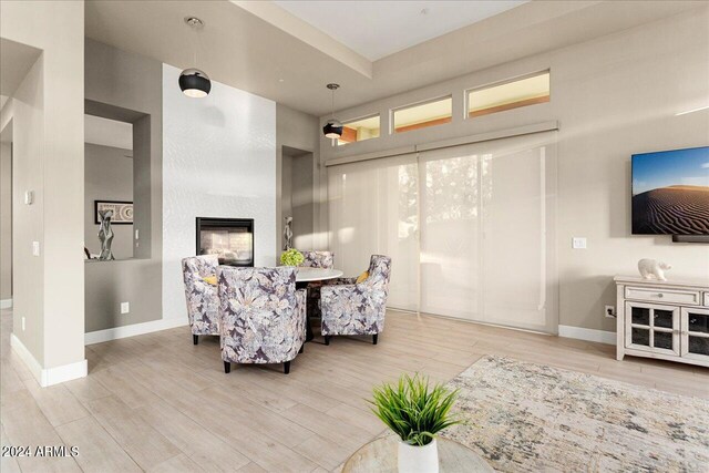 living room with ceiling fan and light wood-type flooring