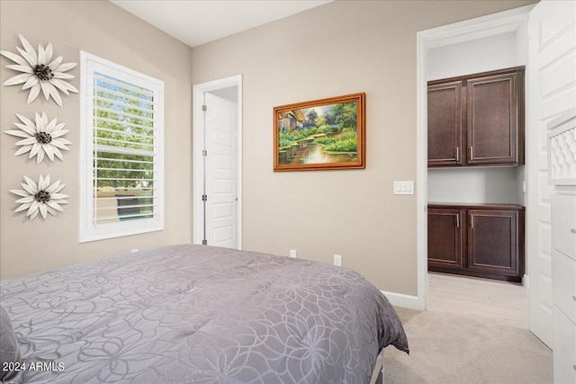 bedroom featuring light colored carpet