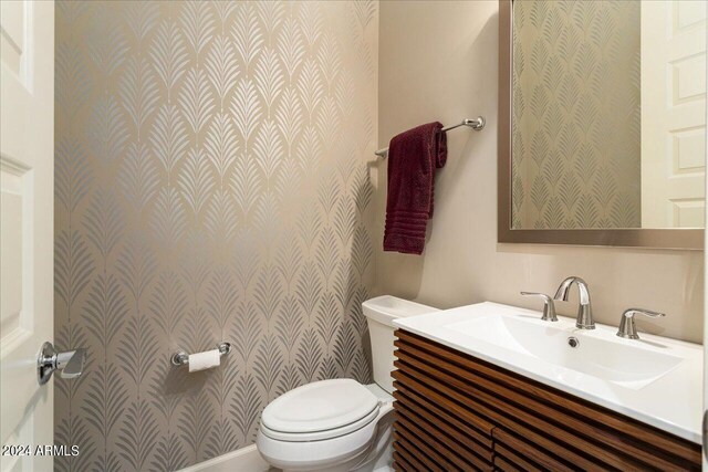 carpeted bedroom featuring sink and ensuite bathroom