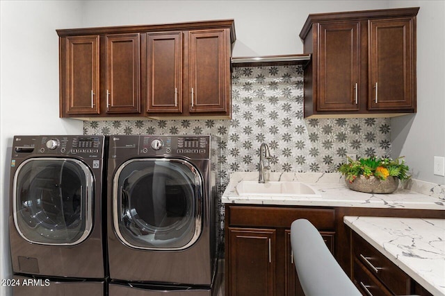 clothes washing area featuring cabinets, separate washer and dryer, and sink