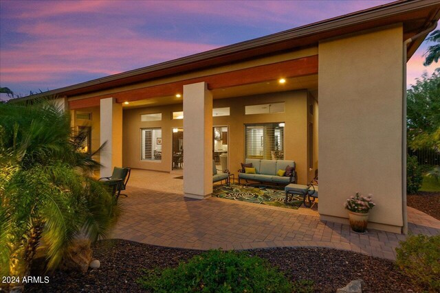 patio terrace at dusk featuring a fire pit