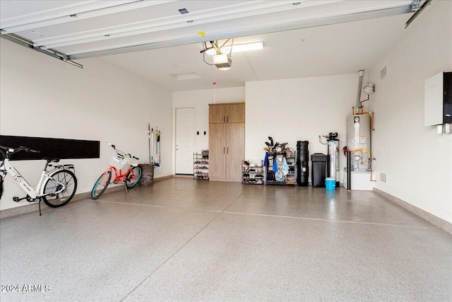 garage featuring gas water heater and a garage door opener