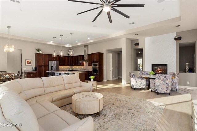 living area featuring ceiling fan and light wood-type flooring