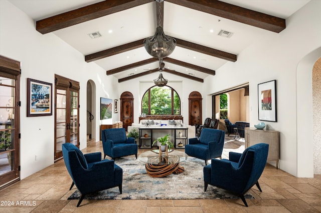 living area with high vaulted ceiling and beam ceiling