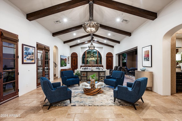 living area featuring high vaulted ceiling, beam ceiling, and a notable chandelier