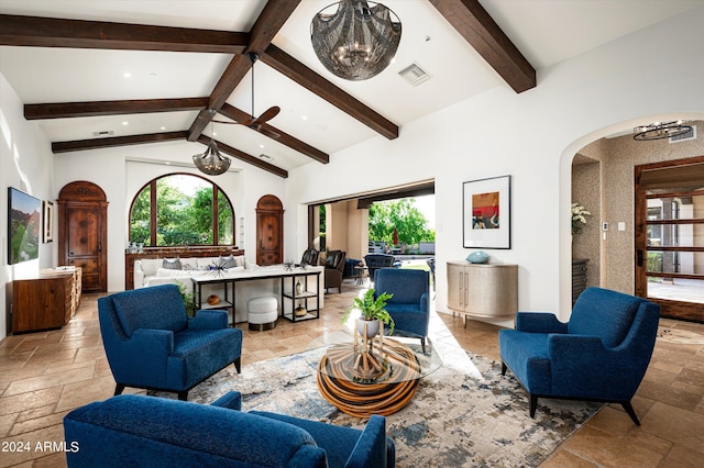 living room with a fireplace, high vaulted ceiling, beam ceiling, and ceiling fan