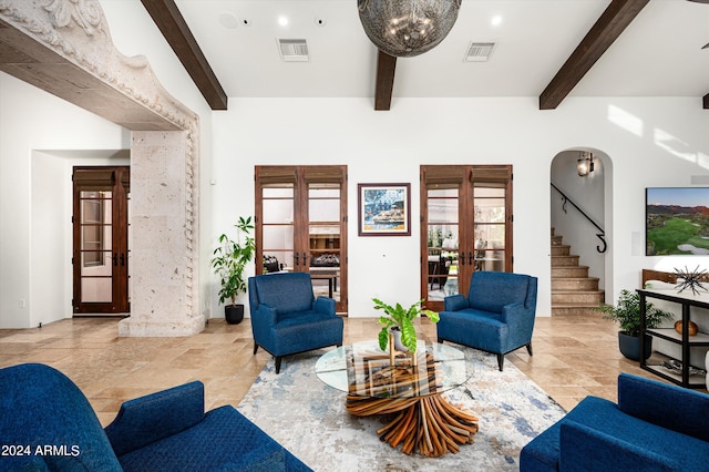 living room with french doors and beamed ceiling