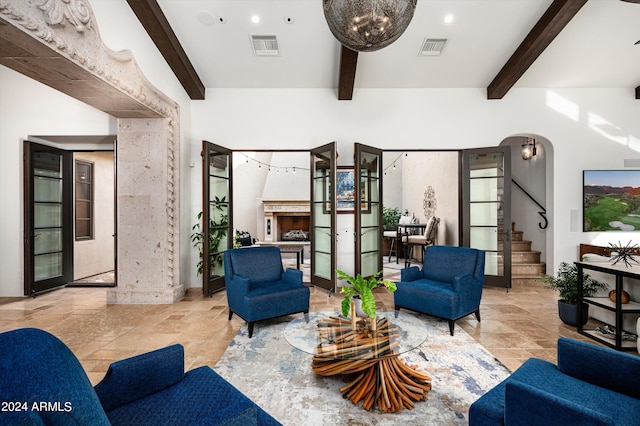 living room with beamed ceiling and french doors