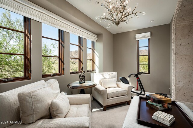 sitting room with a chandelier and carpet floors