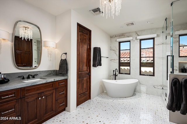 bathroom with separate shower and tub, an inviting chandelier, and vanity