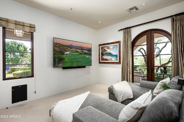 carpeted living room with french doors and a healthy amount of sunlight