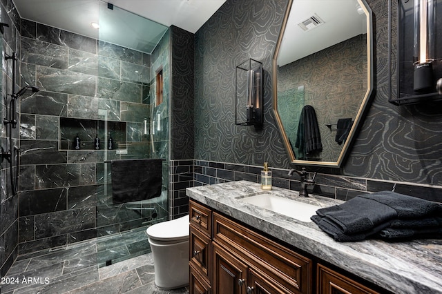 bathroom with vanity, tasteful backsplash, tiled shower, tile walls, and toilet