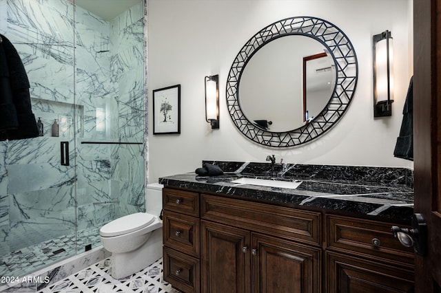 bathroom with vanity, toilet, and an enclosed shower