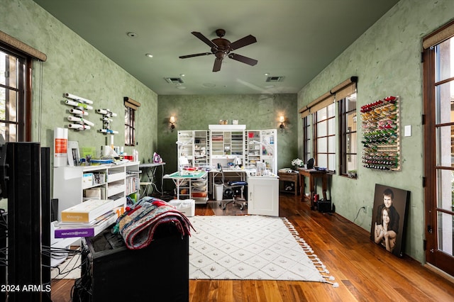 home office with a healthy amount of sunlight and hardwood / wood-style floors