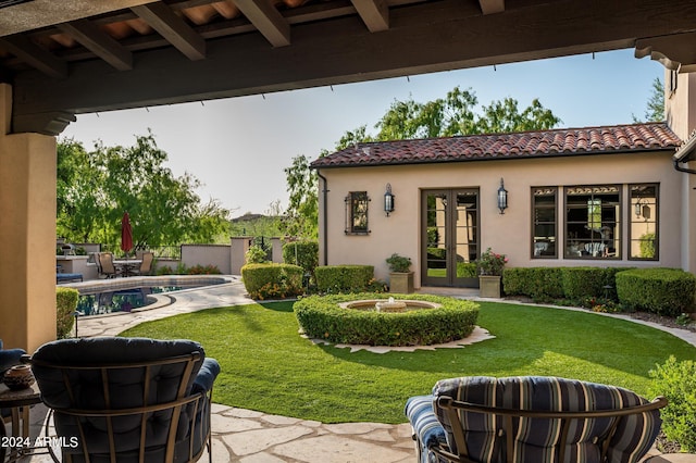 view of yard featuring a fenced in pool, french doors, and a patio area