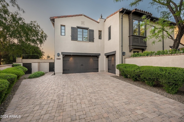 mediterranean / spanish house with a garage