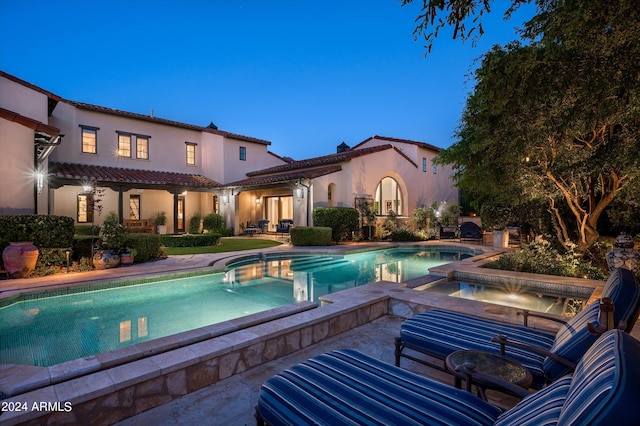 view of swimming pool featuring an in ground hot tub and a patio