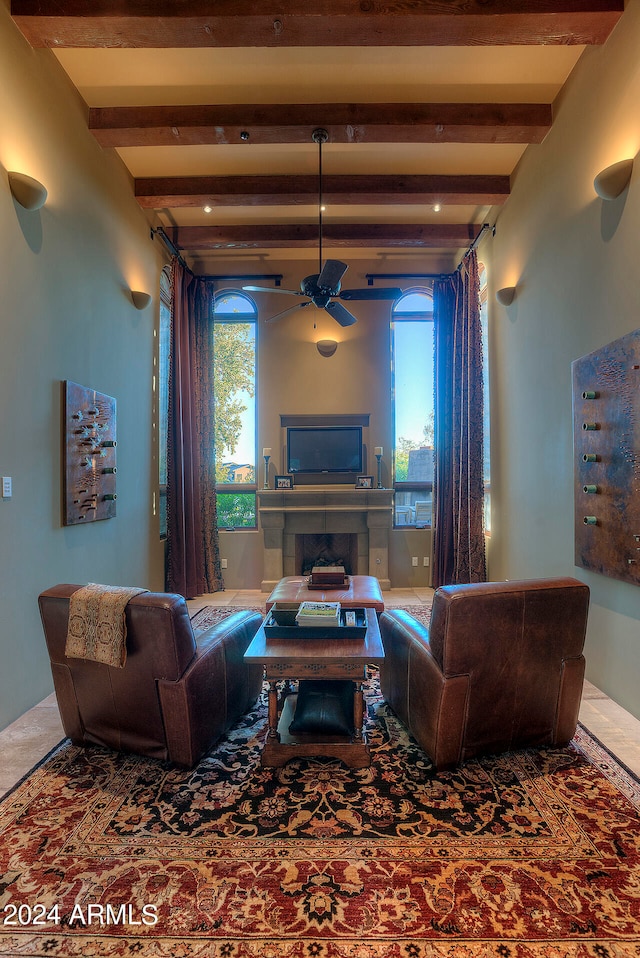 living room with ceiling fan and beam ceiling