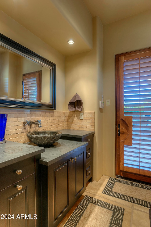 bathroom featuring decorative backsplash and vanity