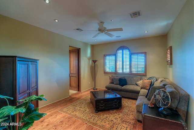 living room featuring ceiling fan and light hardwood / wood-style floors