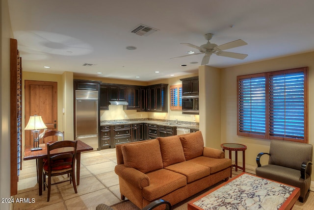 tiled living room featuring ceiling fan