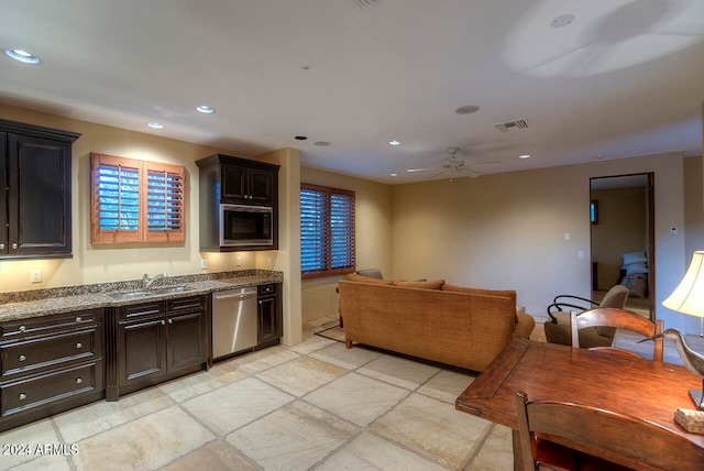 kitchen with ceiling fan, dishwasher, sink, built in microwave, and dark brown cabinets