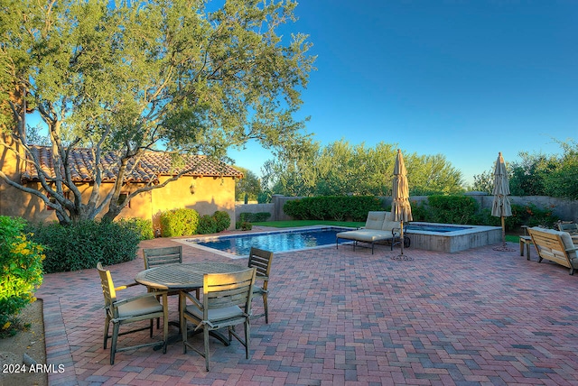 view of pool featuring an in ground hot tub and a patio area