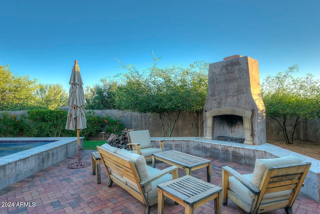 view of patio / terrace with exterior fireplace