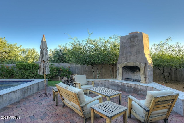 view of patio / terrace with exterior fireplace