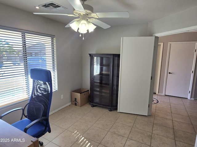 office space featuring light tile patterned flooring, ceiling fan, and plenty of natural light